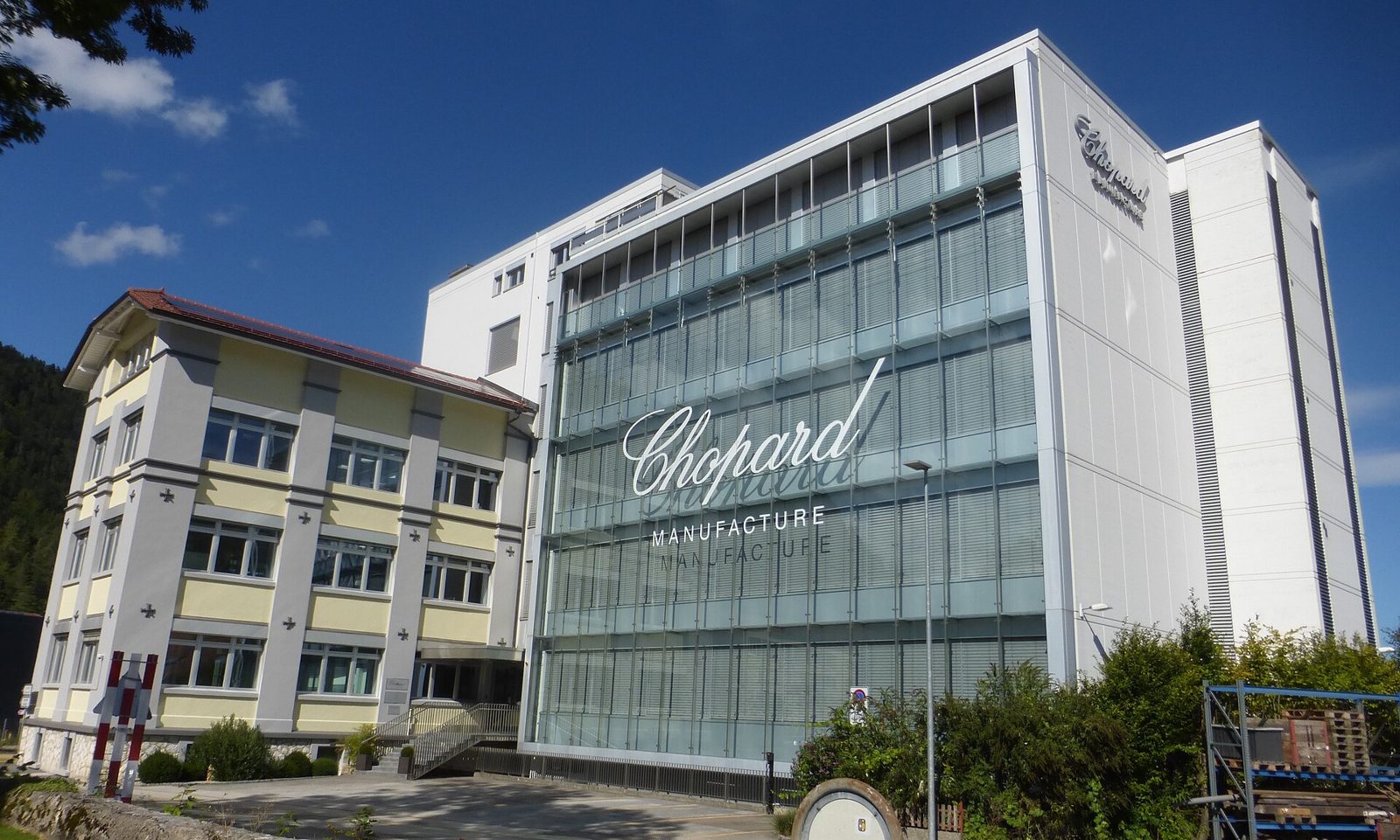 Gebäude der Chopard Manufacture in Fleurier mit gläserner Fassade und dem Schriftzug Chopard Manufacture